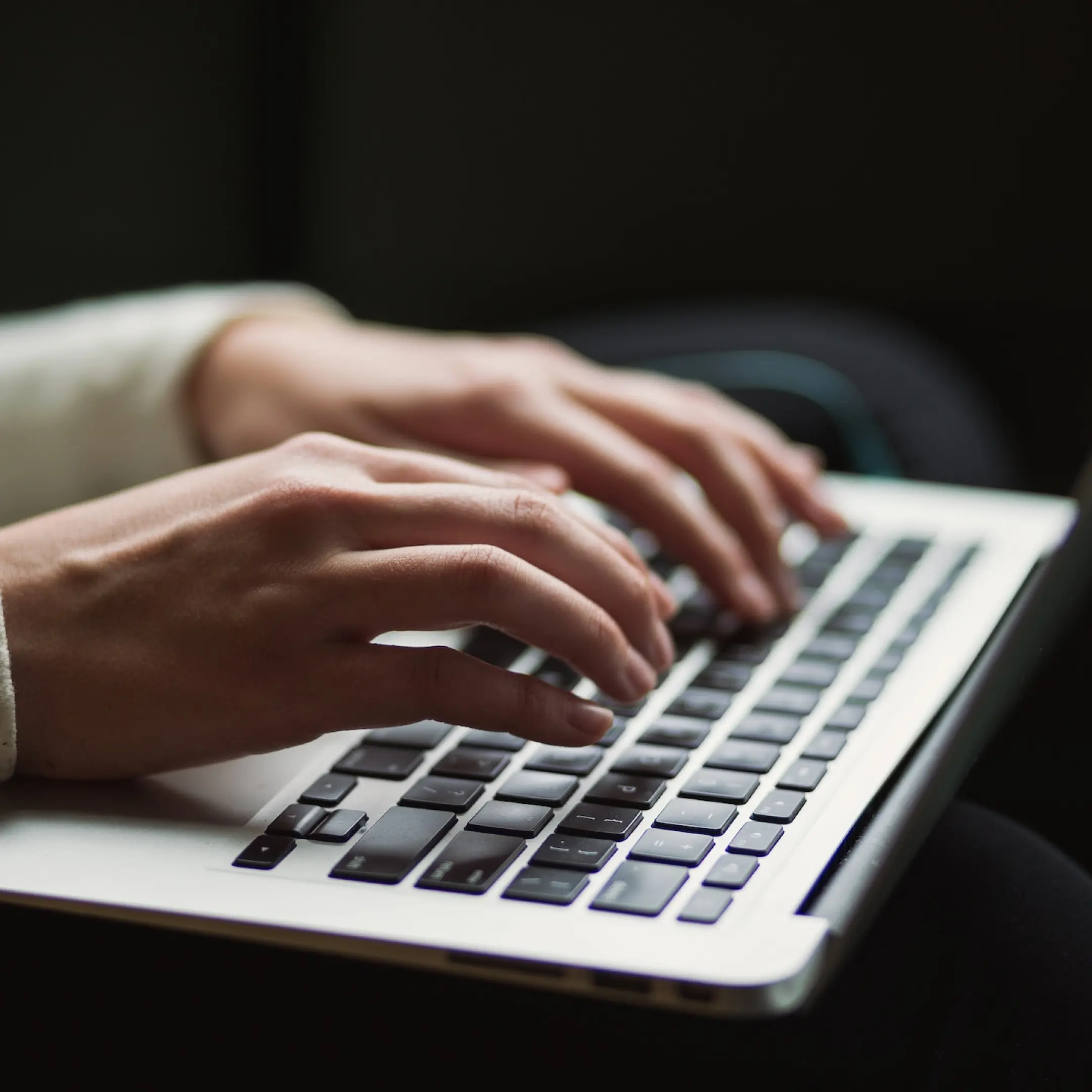 Color photo of image typing on keyboard.